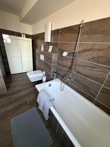 a bathroom with a bath tub and a toilet at Jaegersruh Vicht in Fleuth