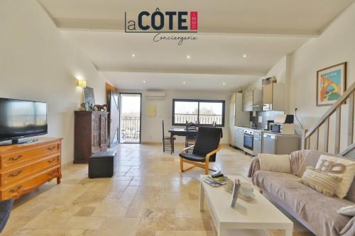 a living room with a couch and a table at A La Vaquera - Gîte équestre in Châteauneuf-lès-Martigues