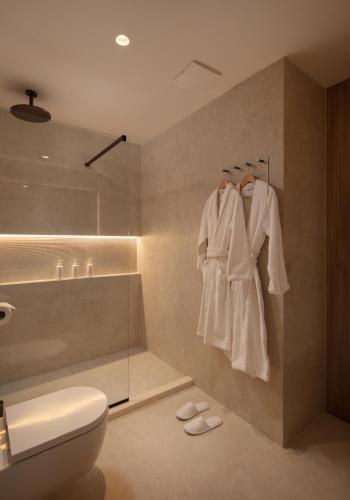 a bathroom with a shower and a toilet and a sink at Hotel Sumratin in Dubrovnik