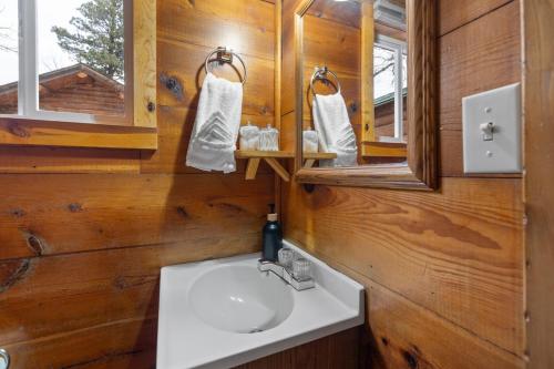 a bathroom with a sink and a mirror at Raven Rock Getaway- Firepit Nights Getaway in Rapid City