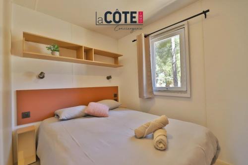 a bedroom with a bed with two pillows on it at Lou Soleil - Bungalow - 6 couchages in Carry-le-Rouet