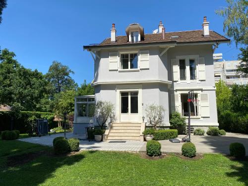 a white house with a roof at Residence Mont-Blanc in Geneva