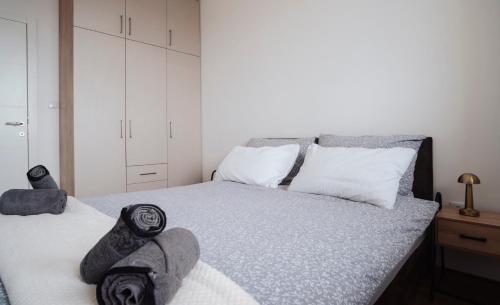 a bedroom with a large bed with towels on it at Sky View - Apartment & GARAGE, Banja Luka in Banja Luka
