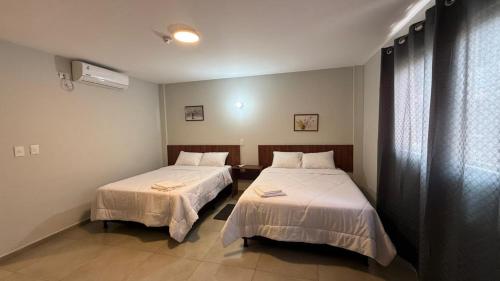 a room with two beds in a room at Hotel Recife in Ciudad del Este
