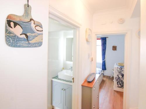 a bathroom with a sink and a mirror at 4 The Elms in Salcombe