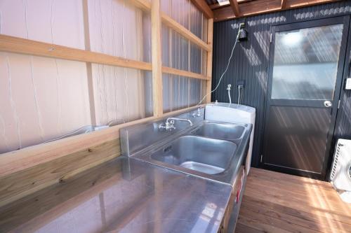 a kitchen with a large stainless steel sink at 皓雲庵plus in Miyakonojō