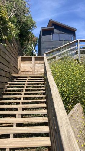 a set of stairs leading up to a house at Tiny House con Vista al Mar, ideal para Teletrabajo o Descanso en Pichilemu in Pichilemu