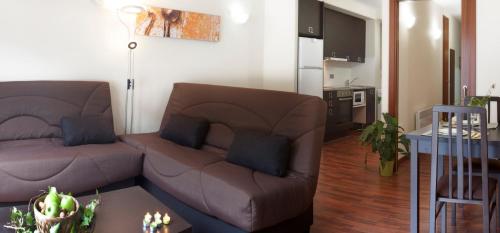 a living room with a couch and a table at Andorra4days Soldeu - El Tarter in Soldeu