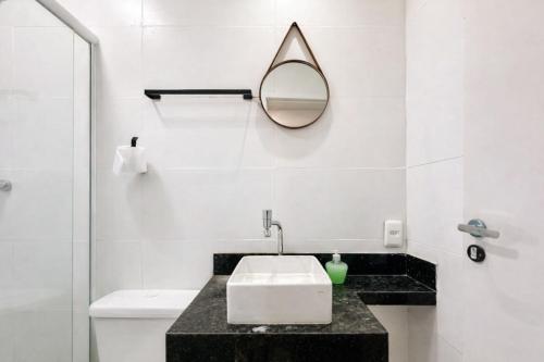 a bathroom with a sink and a mirror at Residencial Dois58 in Niterói