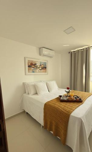 a bedroom with two beds with a tray of food on it at 2 quartos a 300m do mar do bessa in João Pessoa