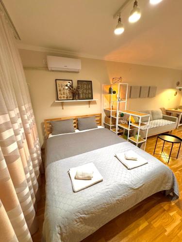 a bedroom with a large bed with towels on it at Studio 4 in Pirot