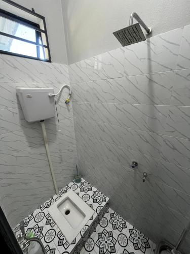a bathroom with a toilet in the floor of a shower at HomeStay Rafiza in Jertih