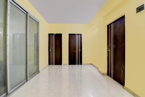a hallway with three doors in a building at Hotel O MAJESTIC M2 INN in New Town