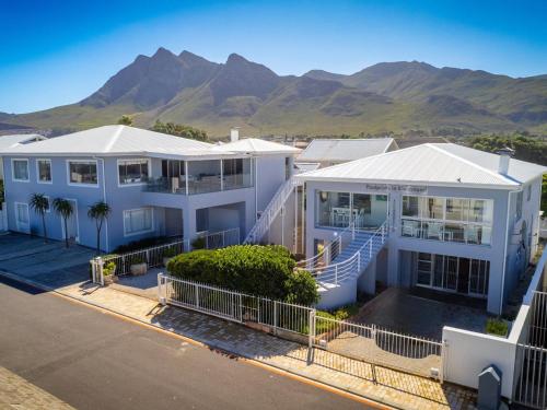 an aerial view of a house with mountains in the background at Footprints in Kleinmond in Kleinmond