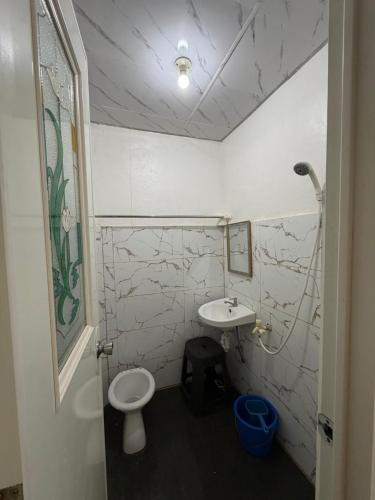 a bathroom with a toilet and a sink at D Haven Space Rental in La Carlota