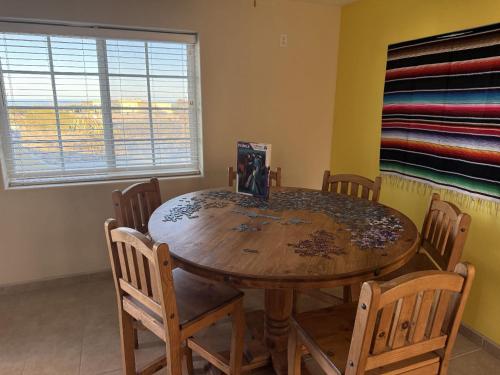 a dining room with a wooden table and chairs at Casa Stu Playa de Oro Rental in San Felipe