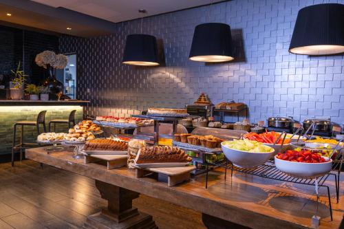 a buffet with many different types of food on a table at Wyndham Santiago Pettra in Santiago
