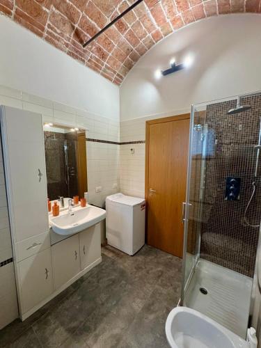 a bathroom with a sink and a shower and a toilet at Casa Barovaldo in Zola Predosa