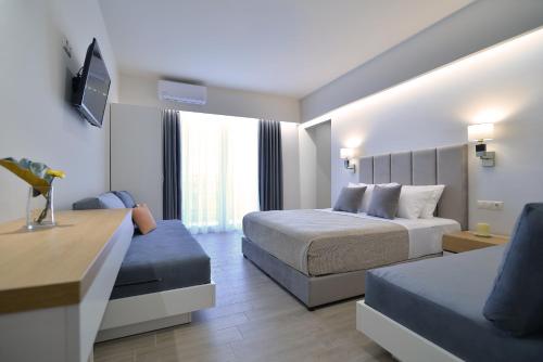 a hotel room with two beds and a couch at Olympus Diamond studios in Olympic Beach