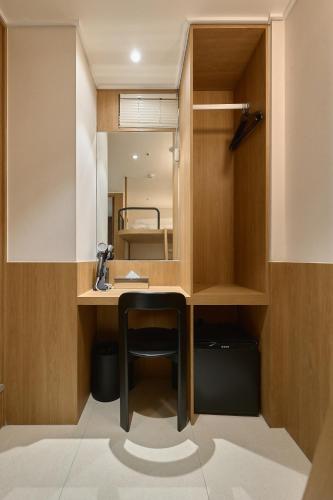 a bathroom with a desk and a mirror at Hotel On You in Seoul