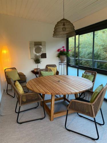 a dining room with a wooden table and chairs at Nära strand och hav in Halmstad