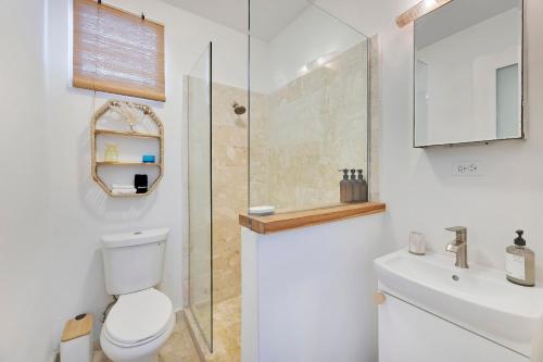 a bathroom with a toilet and a shower and a sink at Boho Oasis by the Beach in San Juan