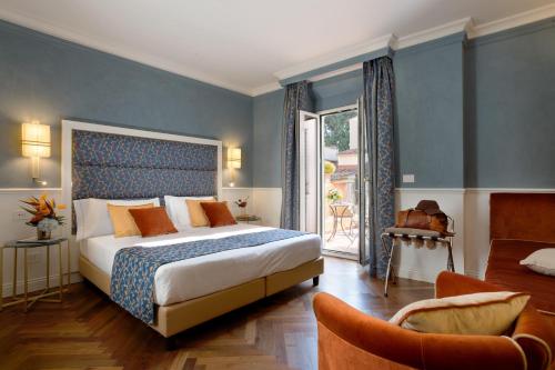 a bedroom with a large bed with blue walls at Rivoli Boutique Hotel in Florence