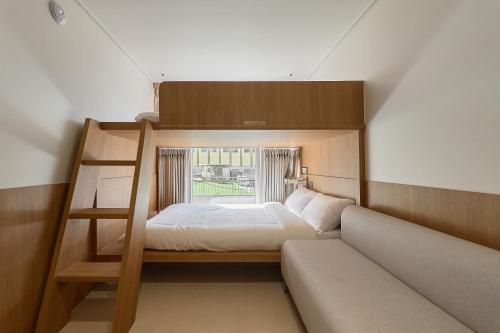 a bedroom with a bunk bed with a window at Hotel On You in Seoul
