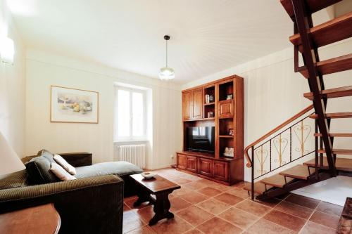 a living room with a couch and a tv at historical townhome in Poppi in Poppi
