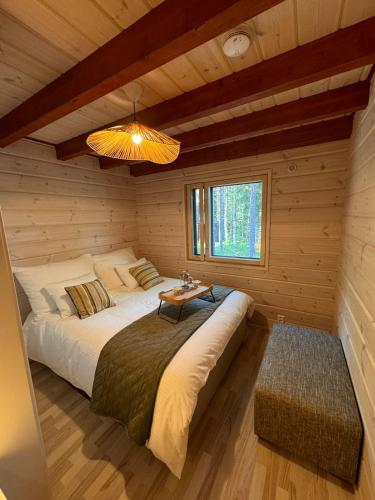 a bedroom with a bed in a log cabin at Chalet Zen Imatra Lake Villa in Imatra