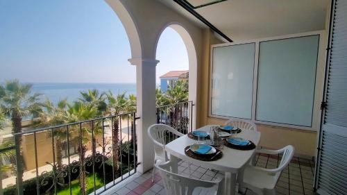 a white table and chairs on a balcony with the ocean at TRILOCALE DIRETTAMENTE SUL MARE- cod 511 in Porto Recanati