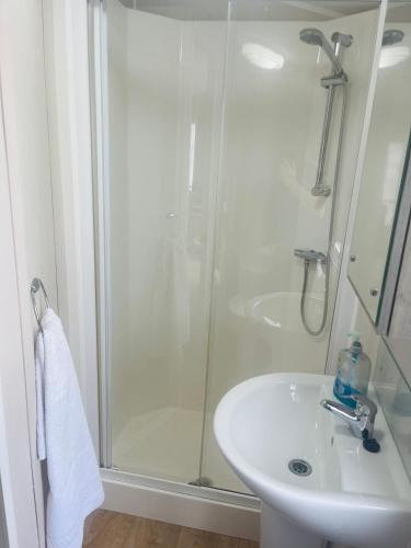 a bathroom with a shower and a sink at Calypso Hot Tub Breaks Tattershall Lakes Pet Friendly in Tattershall