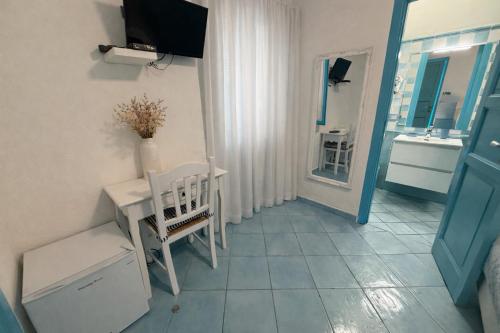 a small room with a table and a sink at La Giara in Vulcano