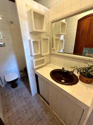 a bathroom with a sink and a mirror at Chill House Buzios in Búzios
