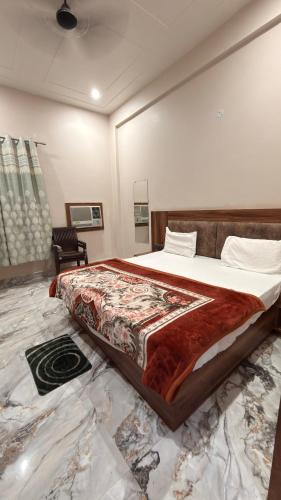 a bedroom with a large bed in a room at Hotel Tara Grand in Mathura
