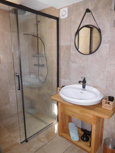 a bathroom with a sink and a shower at le balcon du Canigo' in Escaro