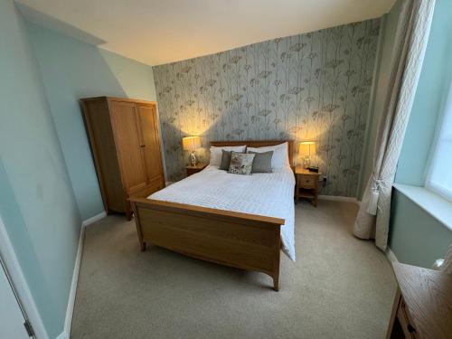 a bedroom with a bed and two lamps on two tables at Rooftops in Louth
