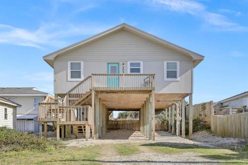 a house with a large deck with a porch at Perched on the Dune In the Heart of Surf City in Surf City