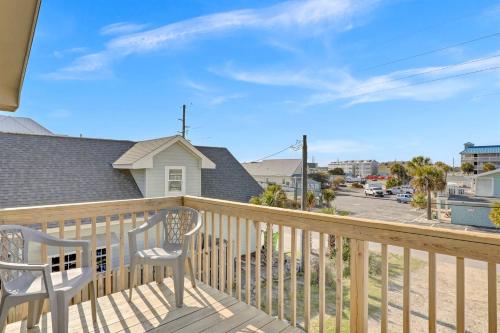 a balcony with two chairs and a view of a street at Perched on the Dune In the Heart of Surf City in Surf City