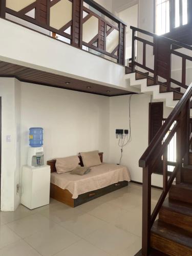 a bedroom with a bed and a stair case at Star HOUSE beach in Aracaju