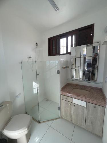 a bathroom with a toilet and a glass shower at Star HOUSE beach in Aracaju