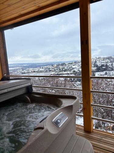 a hot tub on the balcony of a ski resort at Makárlux Vendégház in Pécs