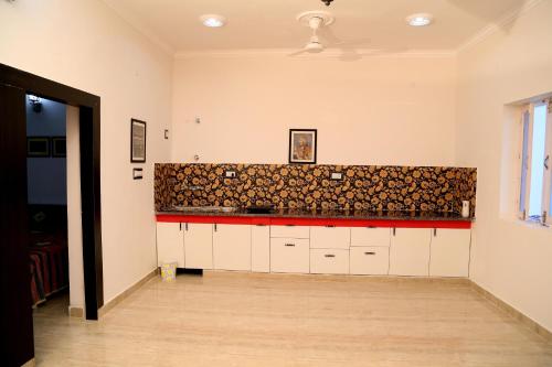 a kitchen with a counter with fire wood at Tuk Tuk Homestay in Agra