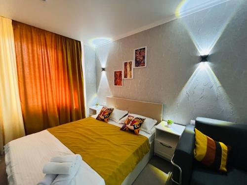 a hotel room with a bed and a chair at Halqyma Hotel in Oral