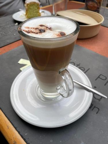 a cup of coffee on a plate on a table at Hotel Plaza Iberia in Tehuacán