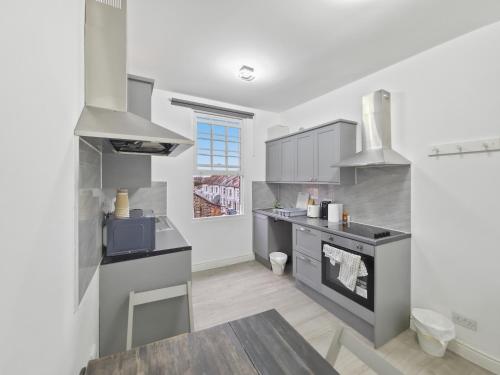 a kitchen with a sink and a stove at London Duo & Quad Rooms in Zone 2 - Willesden Green in London