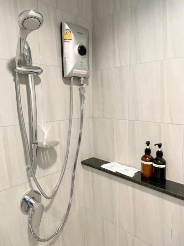 a shower in a bathroom with a shower head at Sabai Residence @Bangyai in Nonthaburi