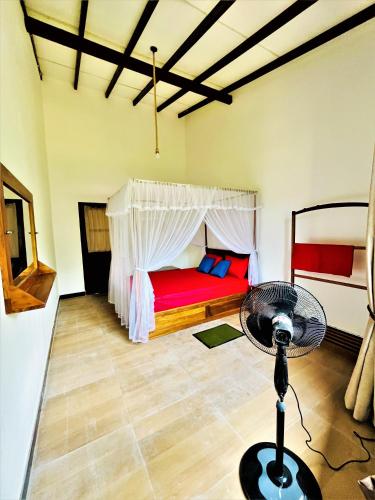 a bedroom with a bed and a fan in a room at Dream Arch ella in Demodera