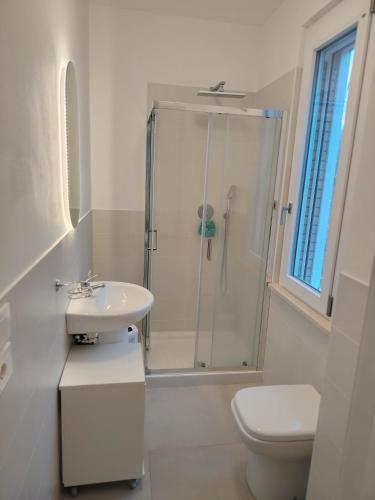 a bathroom with a shower and a sink and a toilet at Bouganvillea in Senigallia