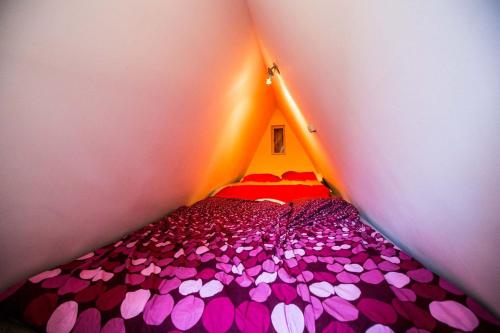 a small room with a bed covered in pink hearts at Ciprus nyaraló in Szarvas